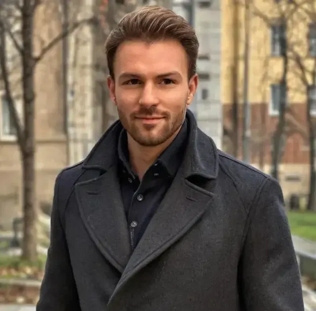 A man in a stylish black coat